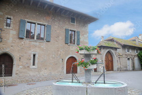 medieveal courtyard with a flower decorated fountain photo