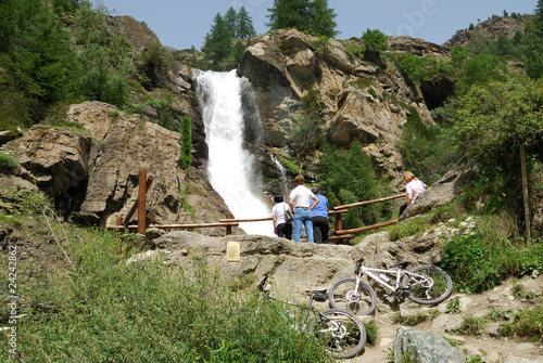 Excursion by bicycle close to a waterfall photo