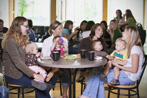 Group Of Young Mothers Relaxing In Cafe
