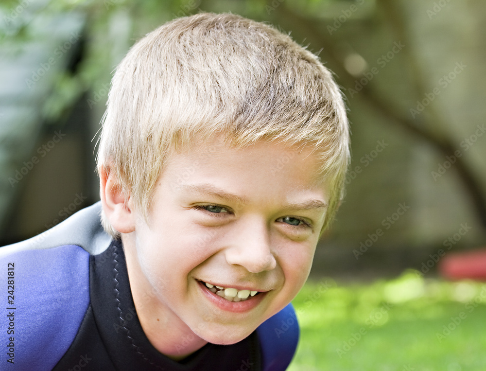 Eight year old boy smiling at the camera Eight year old boy smiling at the camera