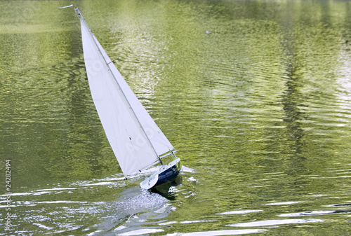 A radio control toy yacht sailing on a lake