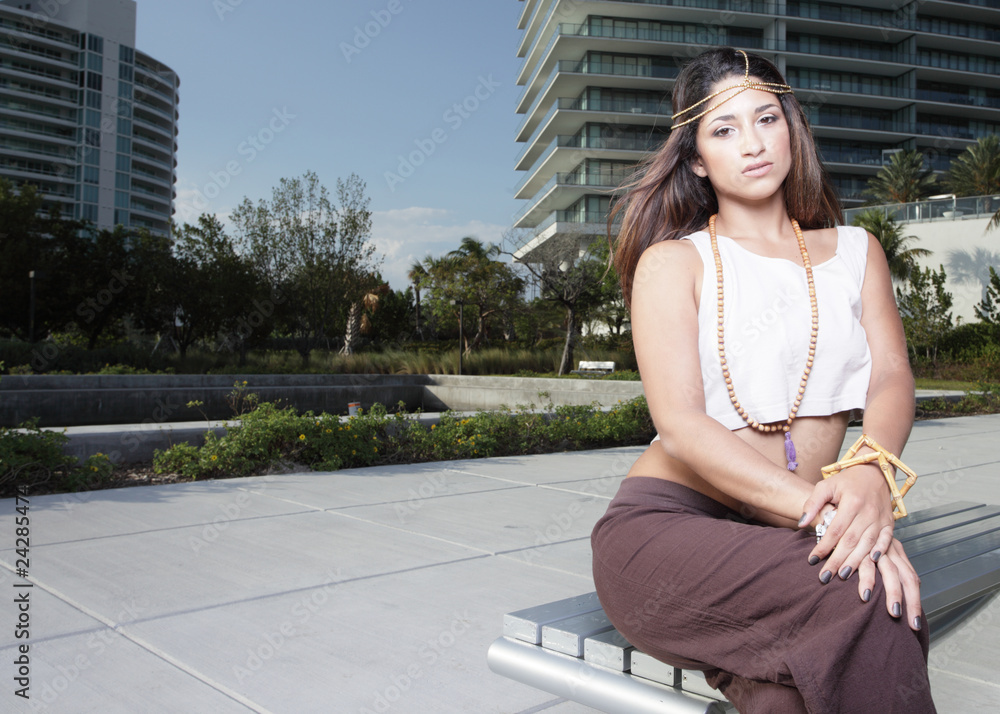 Fototapeta premium Young model sitting on a bench