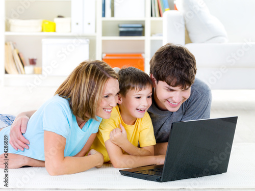 Family with child looking at laptop