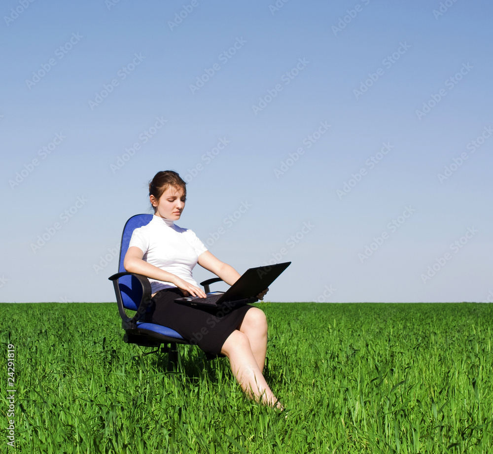Confident businesswoman sitting in an armchair on the field Confident businesswoman sitting in an armchair on the field