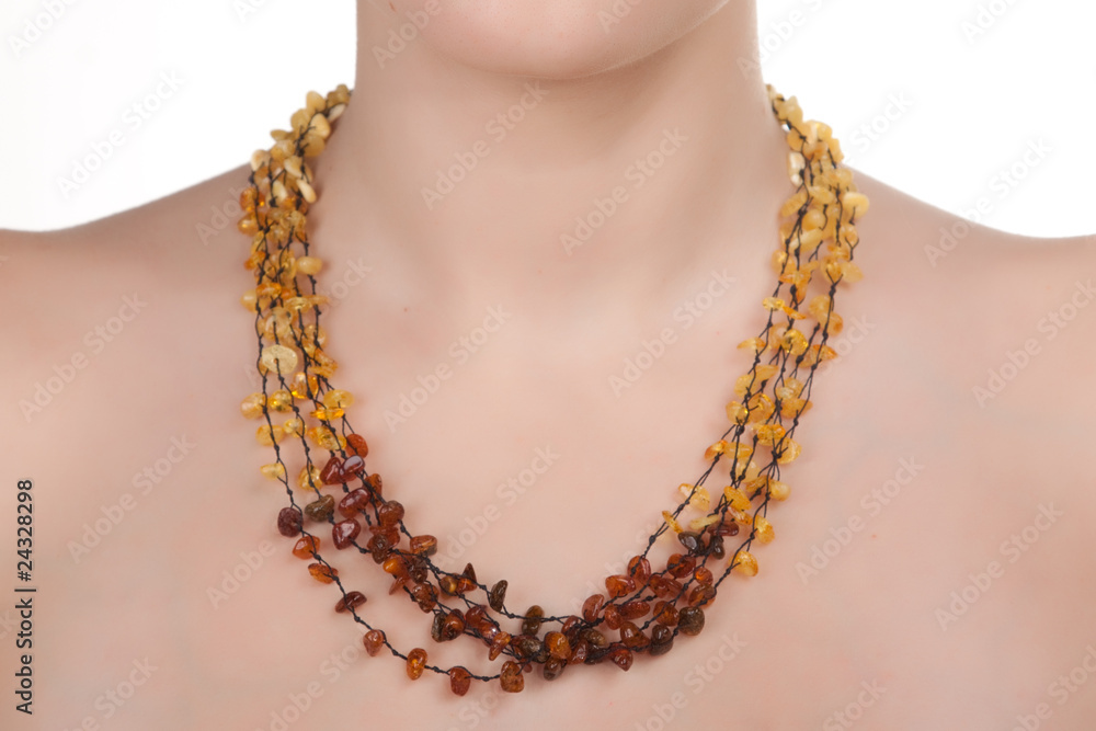 Amber jewelry on female neck.