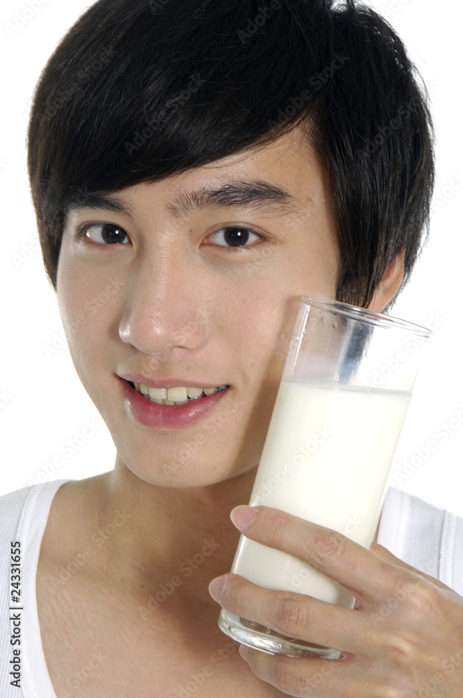 Asian young man with glass of milk smiling Asian young man with glass of milk smiling