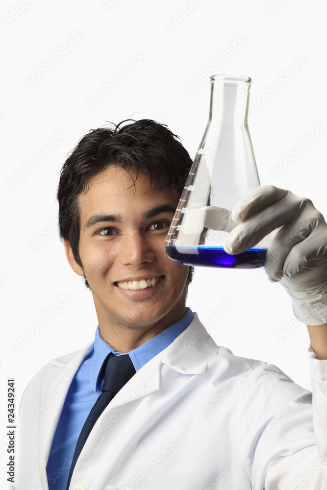 lab technician holding a flask with a fluid inside lab technician holding a flask with a fluid inside