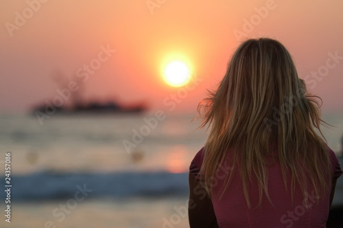 Blond woman watching sunset in Puerto Escondido, Mexico