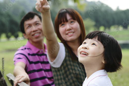A happy Asian family at a park