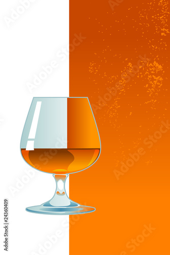 Glass of whiskey on orange background.