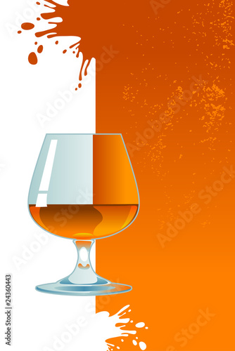 Glass of whiskey on orange background.