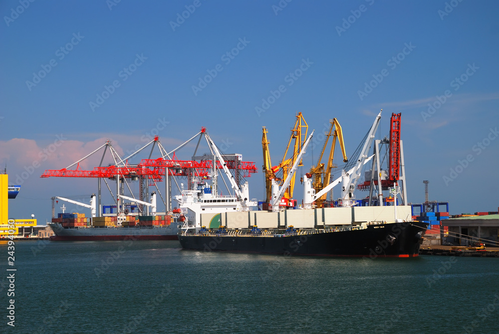 The trading seaport with cranes, cargoes and ship