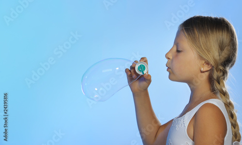 The pretty girl with soap bubbles
