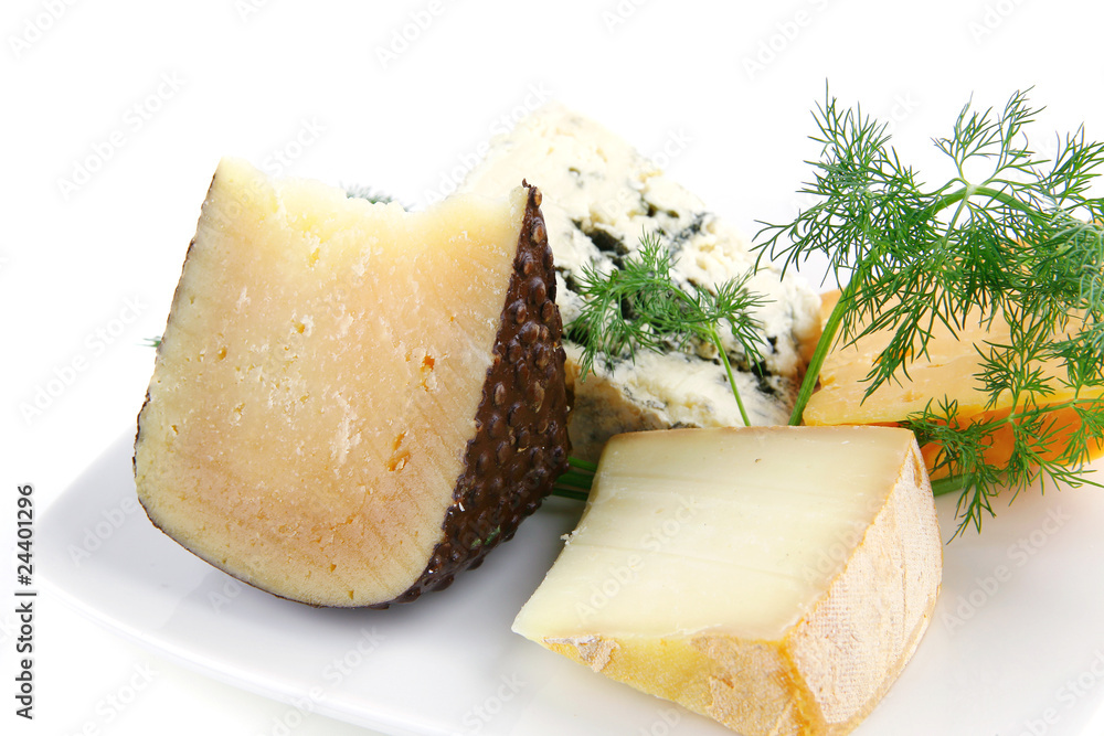 aged cheeses on white porcelain plate