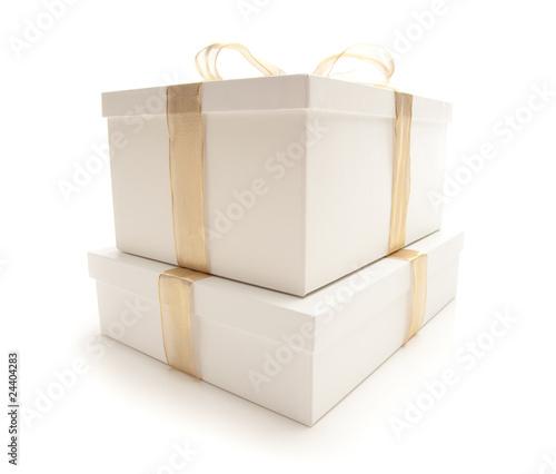 Stacked White Gift Boxes with Gold Ribbon Isolated