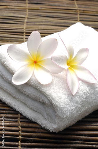 Spa image of frangipani flowers and towel