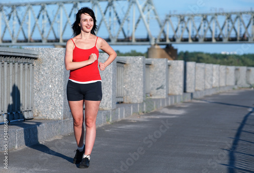 Woman race walking at the embankment
