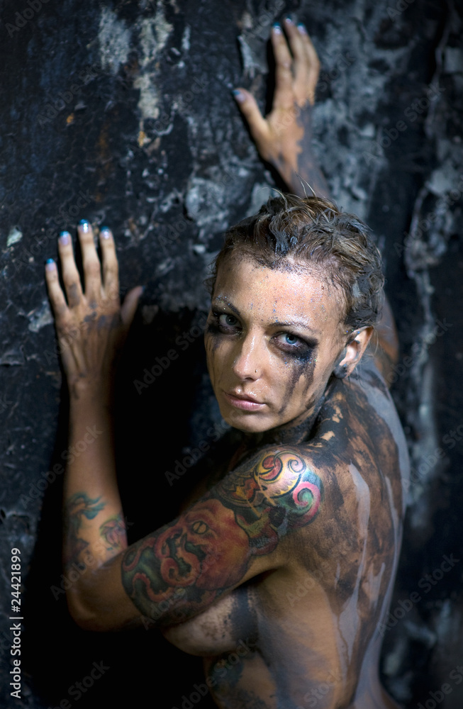 Pretty naked woman with many tattoos on her breast and arms Pretty naked woman with many tattoos on her breast and arms
