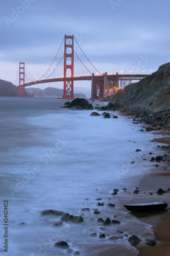 Golden Gate Bridge with a boat as seen from Baker Beach.