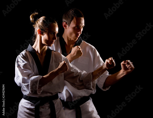 People in kimono make martial arts exercise