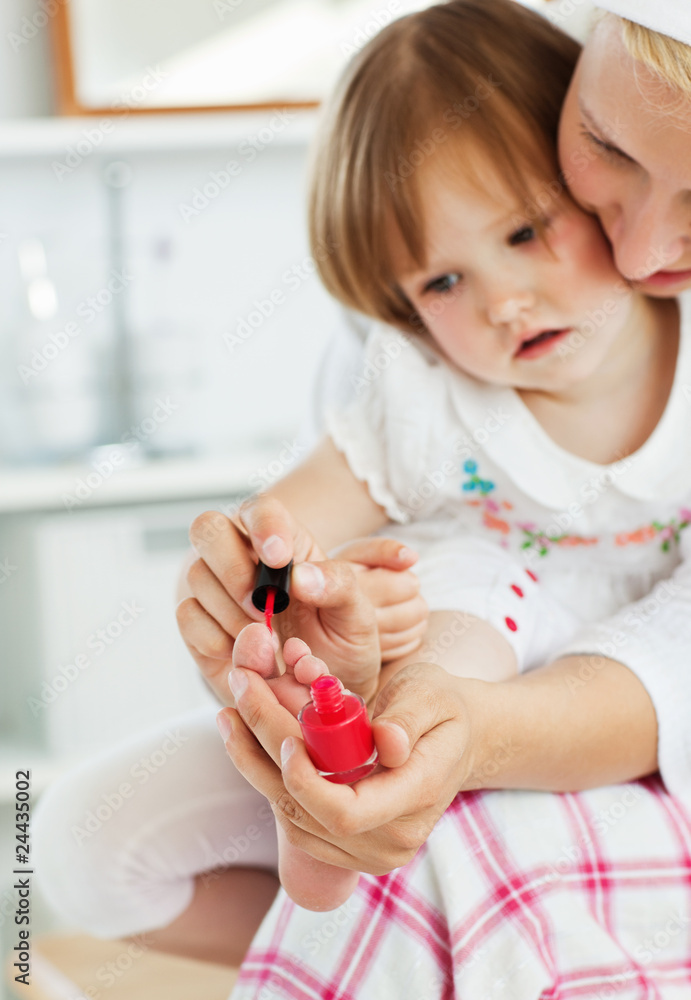 Mother playing with her amazed daughter