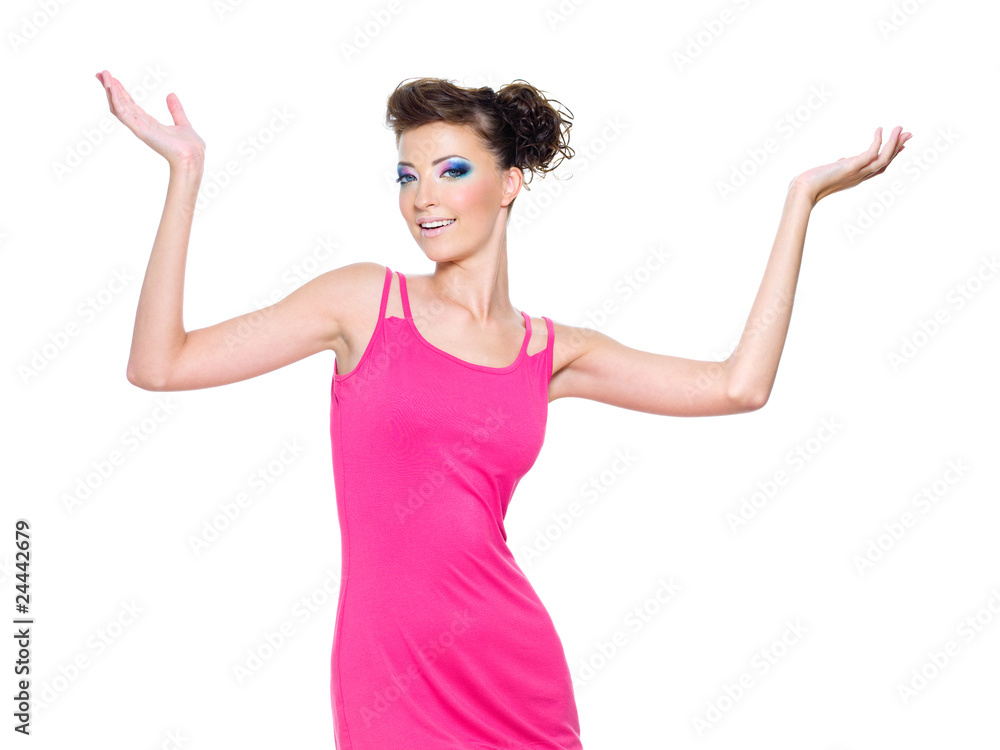 woman posing in pink with hands lifted upwards woman posing in pink with hands lifted upwards