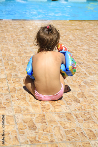 a girl sitting by the pool