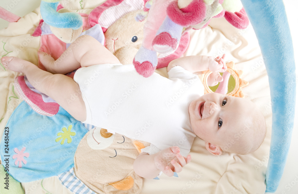 baby girl lying down on playing mat baby girl lying down on playing mat