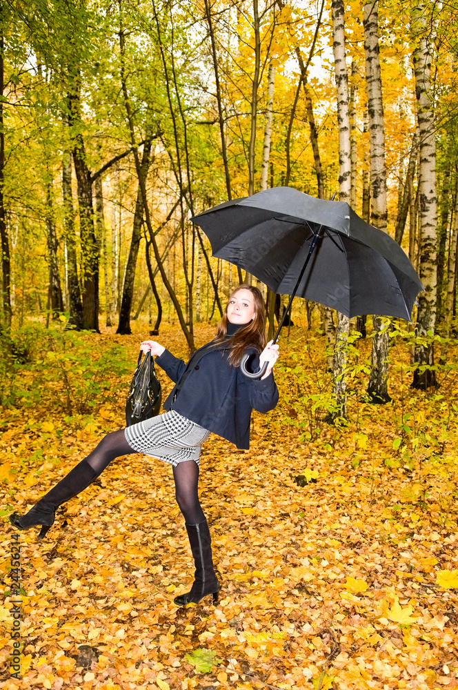 young woman with umbrella in forest
