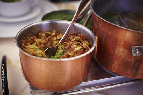 Copper pot with fried potatoes