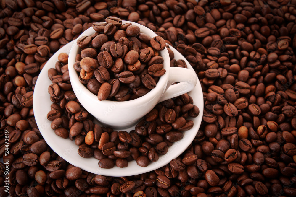 Small white cup of coffee with coffee grain on grain background Small white cup of coffee with coffee grain on grain background