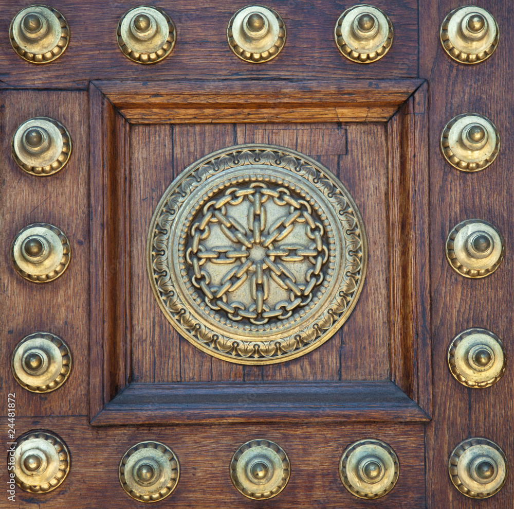 Gold studs and symbol on wooden door Gold studs and symbol on wooden door