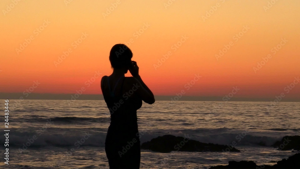 Woman on cell phone at sunset - HD Woman on cell phone at sunset - HD