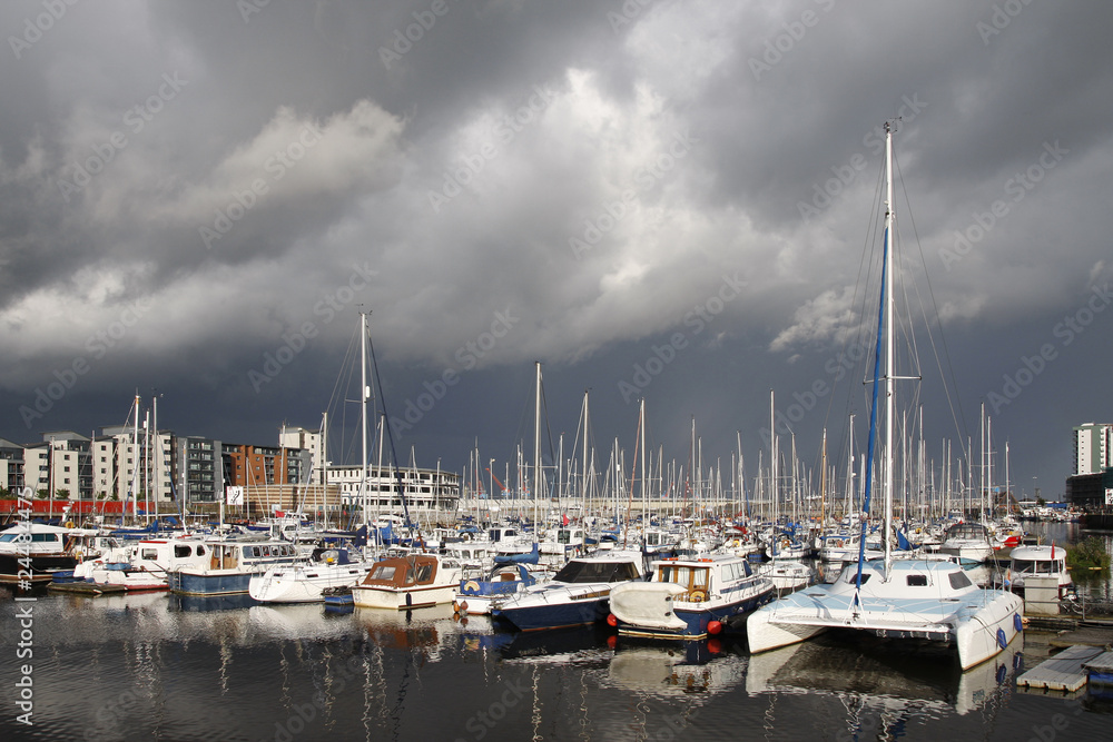 Boats in a marina, stormy sky