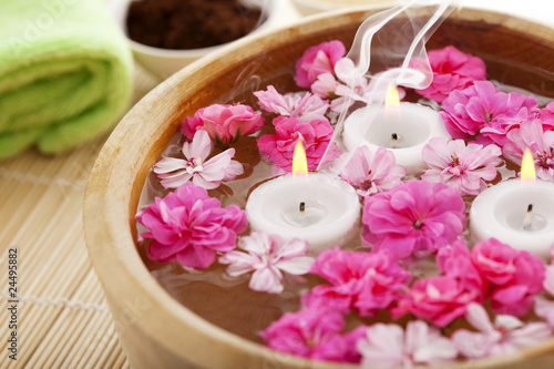 Spa therapy  flowers in water  on a bamboo mat.