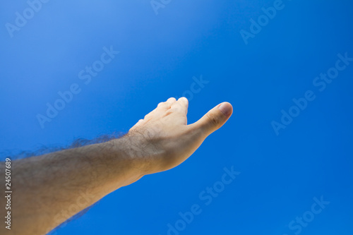Hand against the blue sky