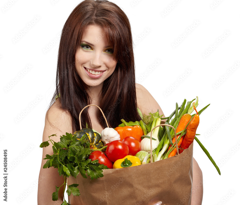 woman holding a grocery bag full of fresh and healthy food woman holding a grocery bag full of fresh and healthy food