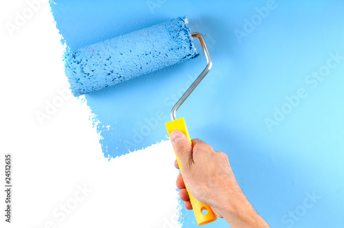 blue color painting wall with roller