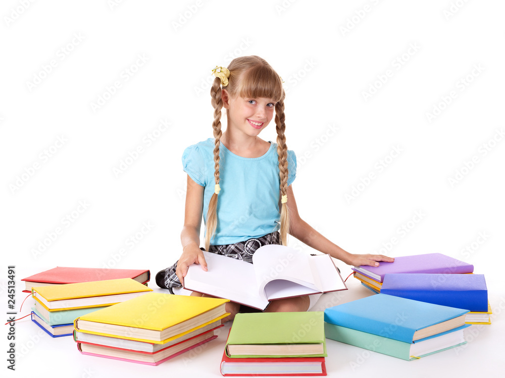 Child with pile of books reading on floor. Child with pile of books reading on floor.