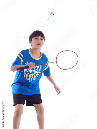 cute boy playing badminton ready to block