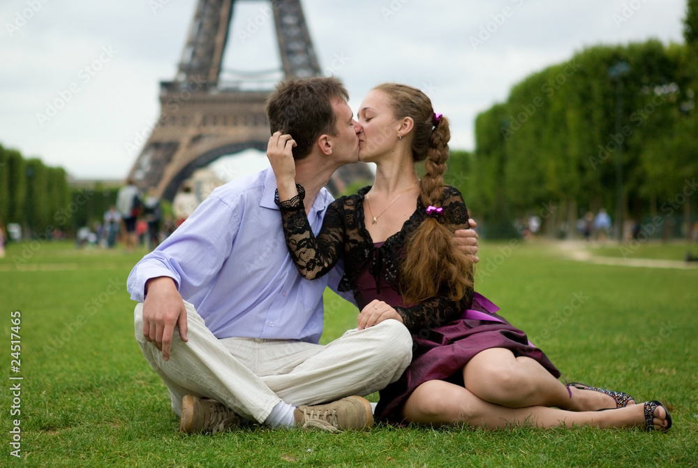 Romantic couple in Paris kissing near the Eiffel Tower Romantic couple in Paris kissing near the Eiffel Tower