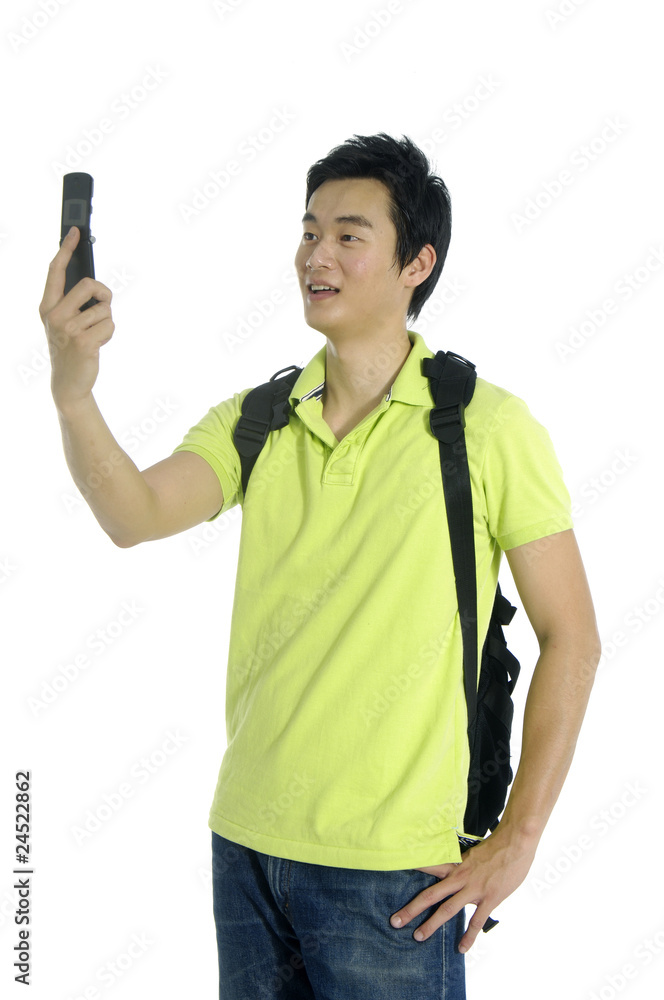 Asian young man using his mobile phone Asian young man using his mobile phone