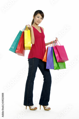 happy young adult girl with colored bags
