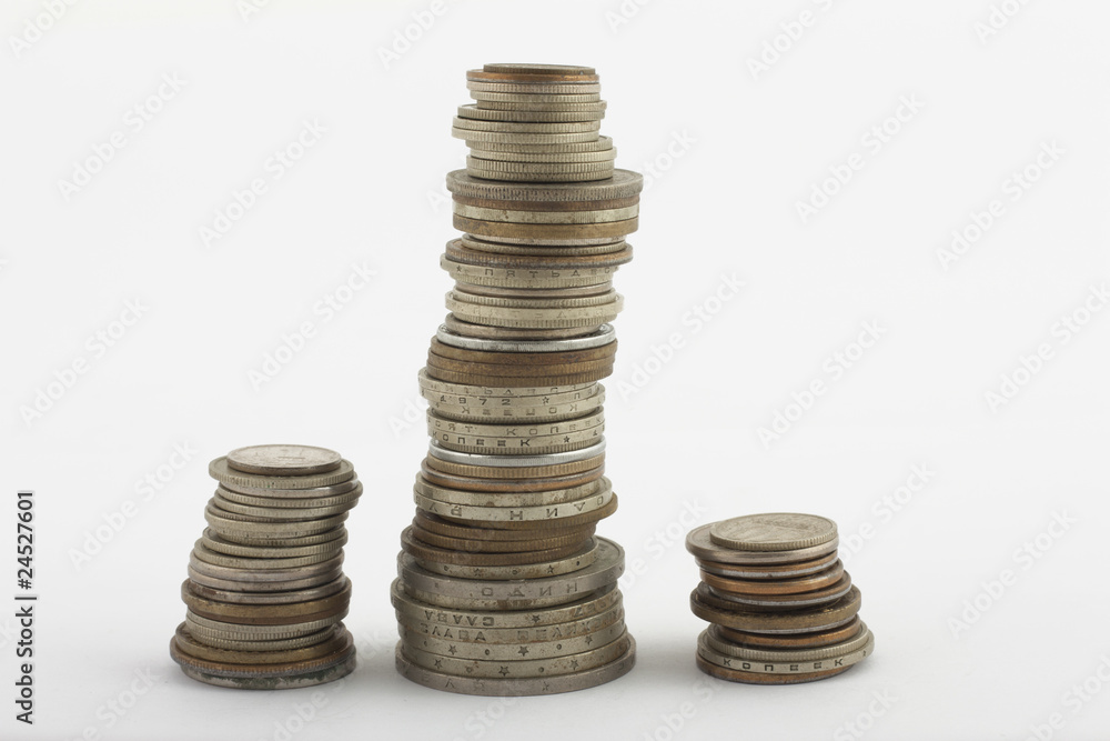 Three columns of coins on white Three columns of coins on white