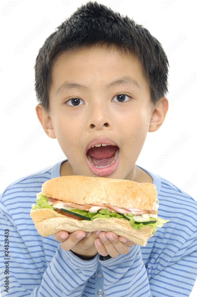 Young boy eating sandwich smiling Young boy eating sandwich smiling