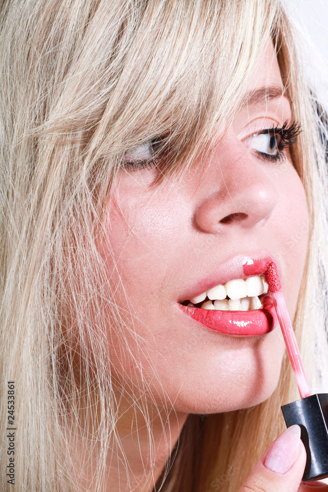 Strikingly Beautiful young blond girl making up her lips Strikingly Beautiful young blond girl making up her lips