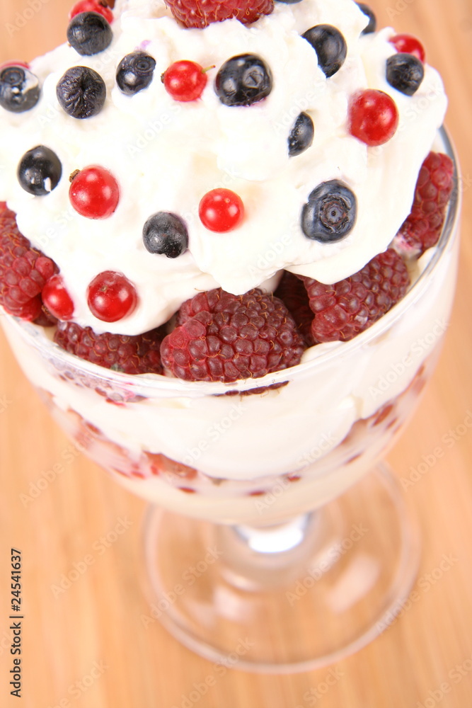 Whipped cream with raspberries, red currants and blue berries Whipped cream with raspberries, red currants and blue berries