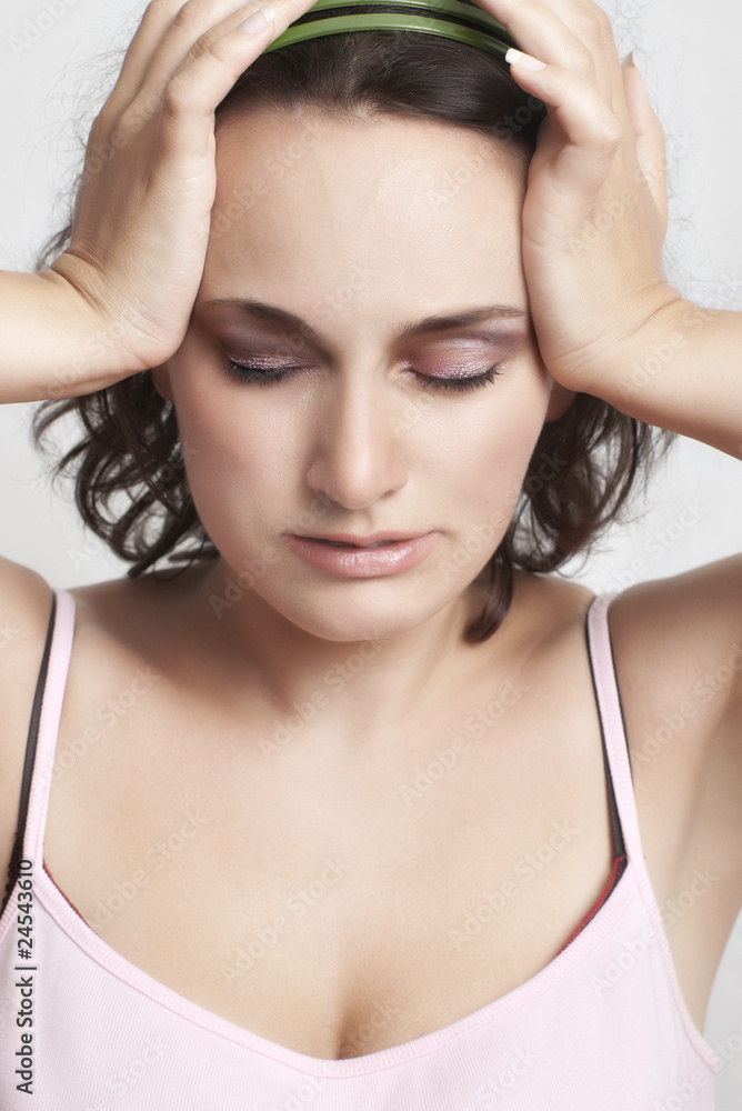 relieved young woman with closed eyes holding her head relieved young woman with closed eyes holding her head