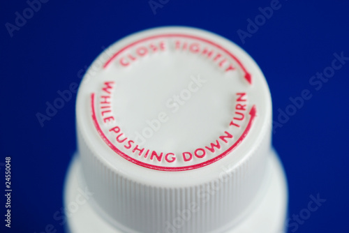 Close up view of a safety caps of a child-proof pill bottle