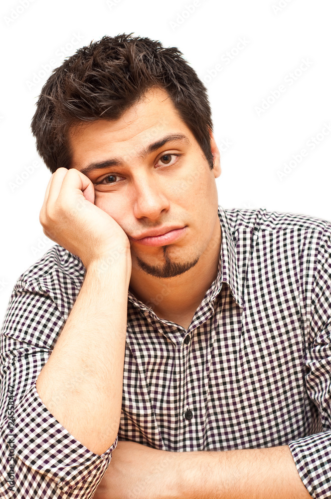 young man with tired, indifferent expression young man with tired, indifferent expression